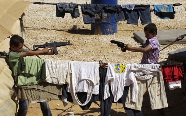 Syrian refugee children who fled the vio...Syrian refugee children who fled the violence in their country, play with guns at the Zaatari refugee camp close to the northern Jordanian city of Mafraq, near the border with Syria, on the first day of the Eid al-Fitr, marking the end of the holy month of Ramadan, on August 19, 2012. Around 3,000 Syrians are taking shelters in the refugee camp that was opened last month to alleviate the humanitarian crisis in Syria. AFP PHOTO/KHALIL MAZRAAWIKHALIL MAZRAAWI/AFP/GettyImages
