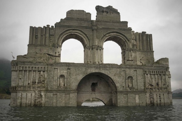 The remains of a mid-16th century church known as the Temple of Santiago, as well as the Temple of Quechula, is visible from the surface of the Grijalva River, which feeds the Nezahualcoyotl reservoir, due to the lack of rain near the town of Nueva Quechula, in Chiapas state, Mexico, Friday, Oct. 16, 2015. It's the second time this has happened. In 2002, the water was so low visitors could walk inside the church. (AP Photo/David von Blohn)