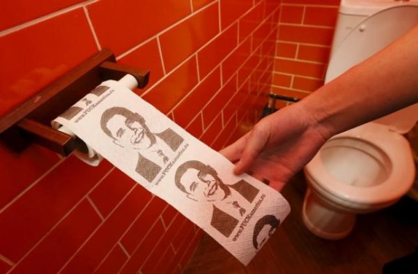 A customer pulls on a roll of toilet paper depicting U.S. President Barack Obama at the "President Cafe" in Krasnoyarsk, Siberia, Russia, April 7, 2016. REUTERS/Ilya Naymushin