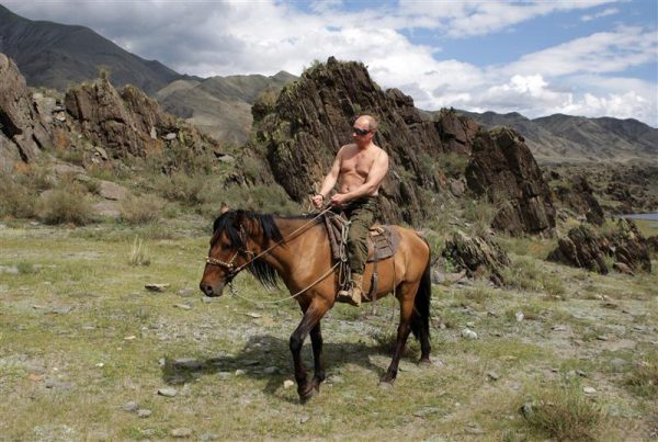 Russia's Prime Minister Vladimir Putin rides a horse in southern Siberia's Tuva region August 3, 2009. Putin, a judo black belt who has flown in a fighter aircraft and shot a Siberian tiger in the wild, plunged into the depths of Lake Baikal aboard a mini-submersible on Saturday in a mission that added a new dimension to his macho image. Picture taken August 3, 2009. REUTERS/RIA Novosti/Pool/Alexei Druzhinin (RUSSIA POLITICS ANIMALS ENVIRONMENT IMAGES OF THE DAY)
